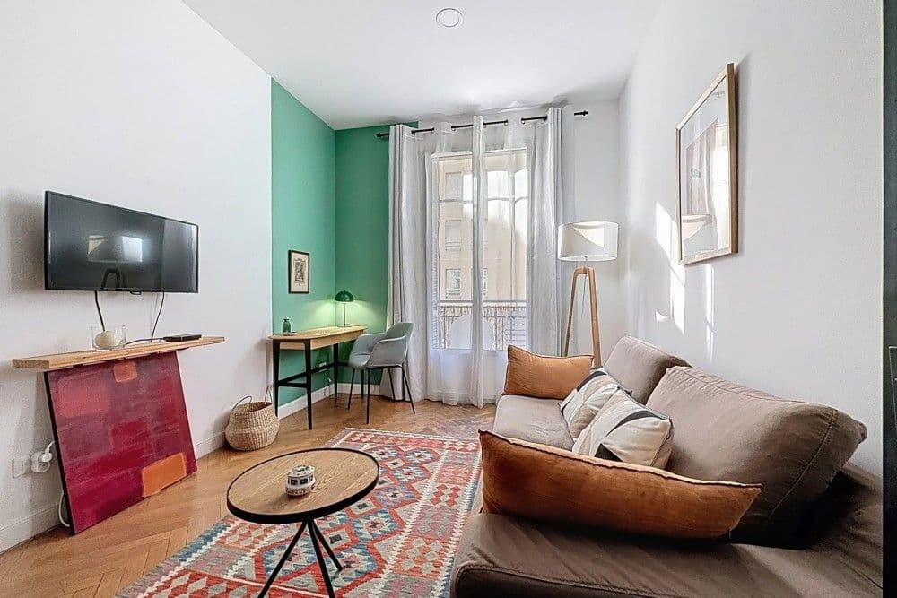 Living room with sofa, kilim rug and French window, 1-bedroom apartment in the Port, Nice