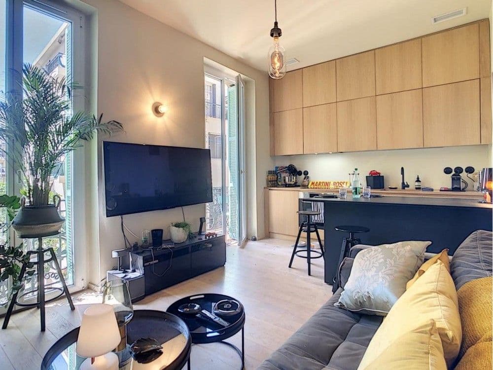 Open-plan living room and kitchen with wood cabinetry, 1-bedroom apartment in the Port, Nice