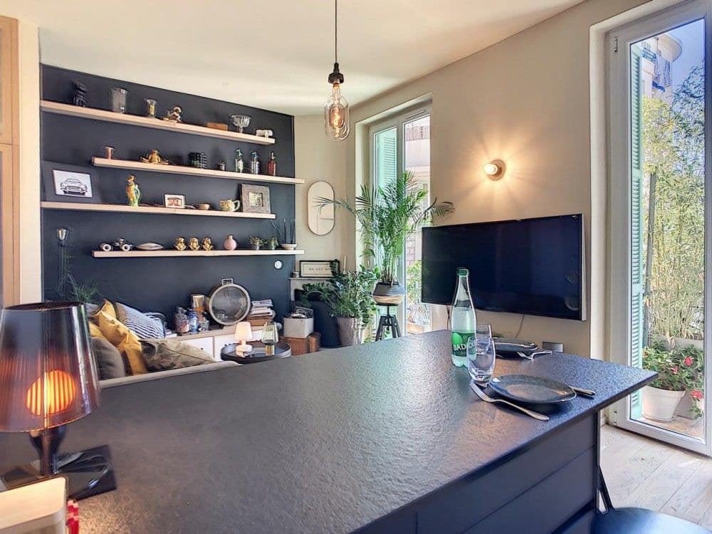 Living room with display shelving, sofa and French window, 1-bedroom apartment in the Port, Nice