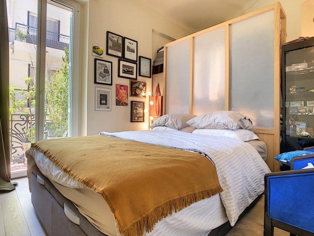Bedroom with framed pictures and French window to the balcony, 1-bedroom apartment in the Port, Nice