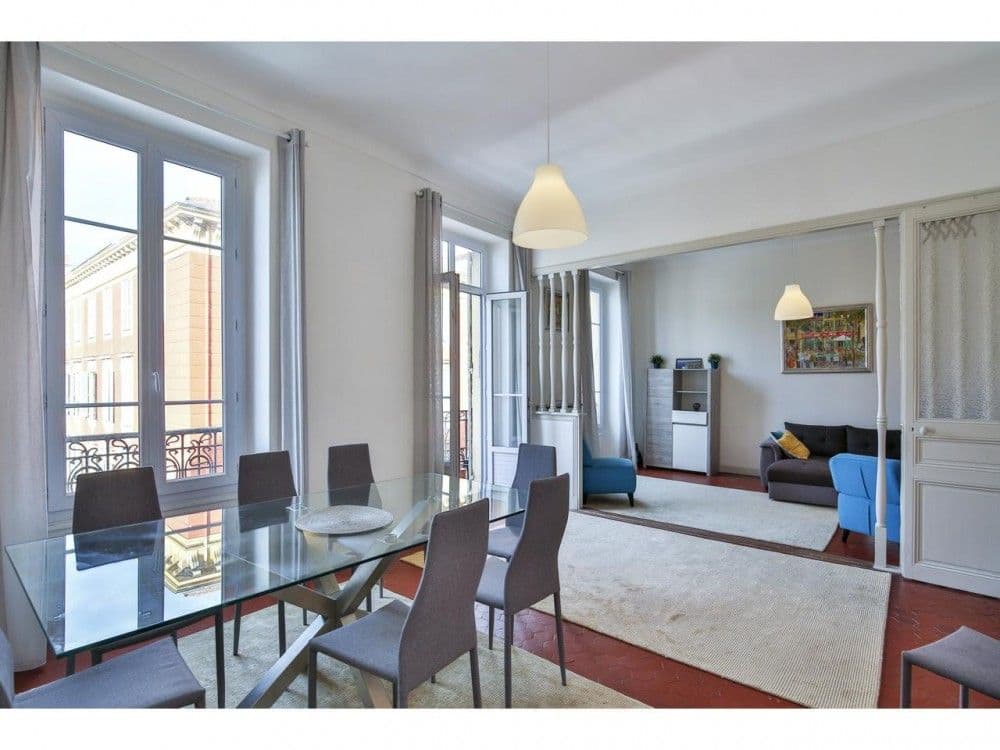 Dining room with glass table and the living room beyond, 2-bedroom apartment in the Port, Nice