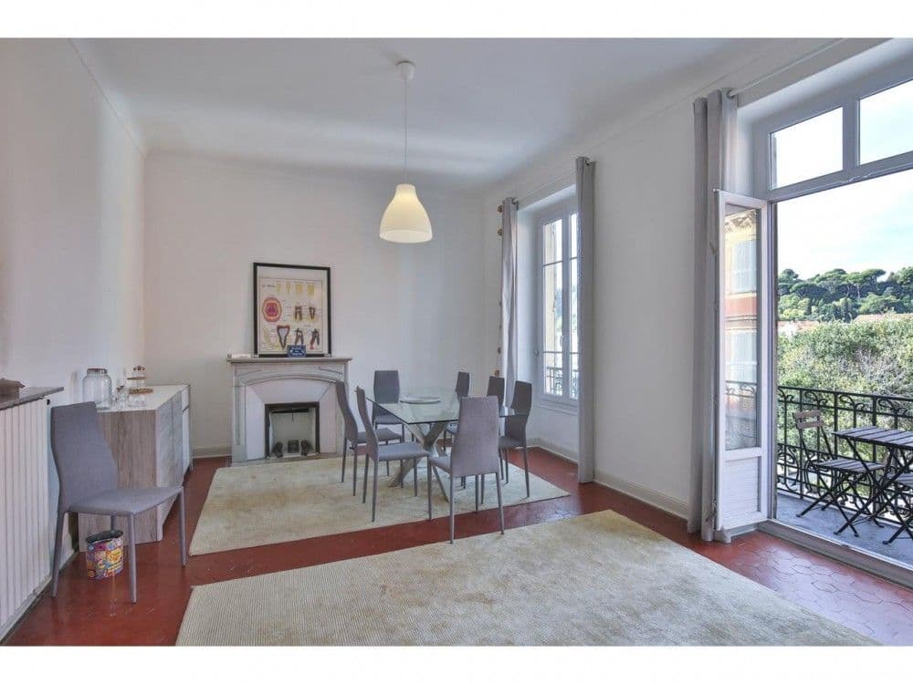 Dining room with fireplace and harbour view from the balcony, 2-bedroom apartment in the Port, Nice