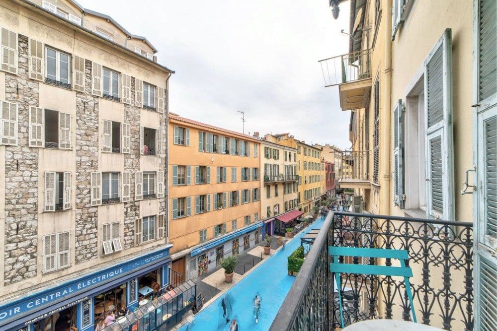 Balcony view down the street with shops below, 1-bedroom apartment in the Port, Nice