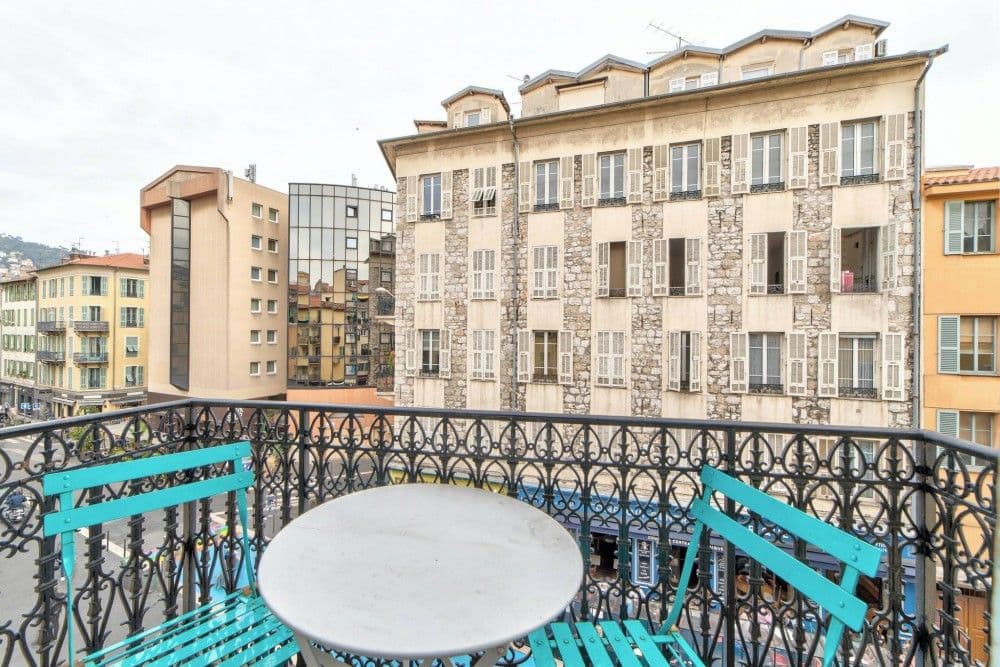 Balcony with bistro table facing the building opposite, 1-bedroom apartment in the Port, Nice