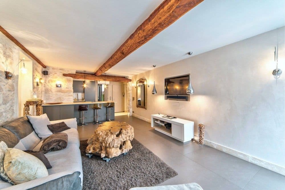 Living room with exposed beams, stone feature and open kitchen, 1-bedroom apartment in the Port, Nice