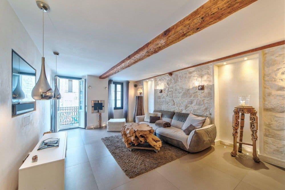Living room with exposed stone walls and pendant lights, 1-bedroom apartment in the Port, Nice