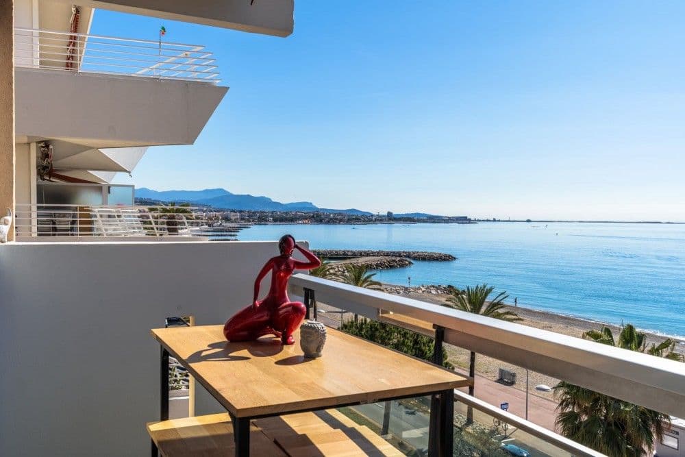 Balcony with table and a view along the coast at Cagnes-sur-Mer, 2-bedroom apartment in Cagnes-sur-Mer