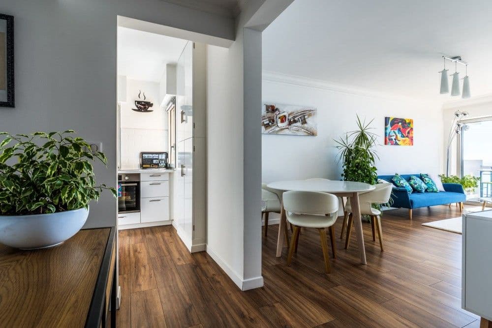 Dining area with wooden floor and kitchen beyond, 2-bedroom apartment in Cagnes-sur-Mer