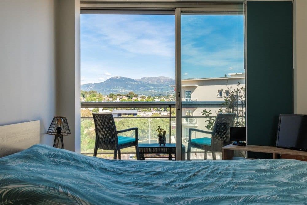Bedroom with a view of the hills from the balcony, 2-bedroom apartment in Cagnes-sur-Mer