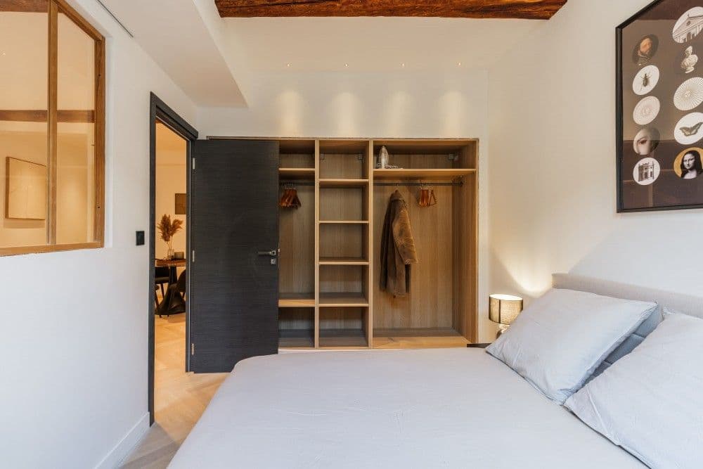 Bedroom with built-in open wardrobe and glass partition, 2-bedroom apartment in the Old Town, Nice