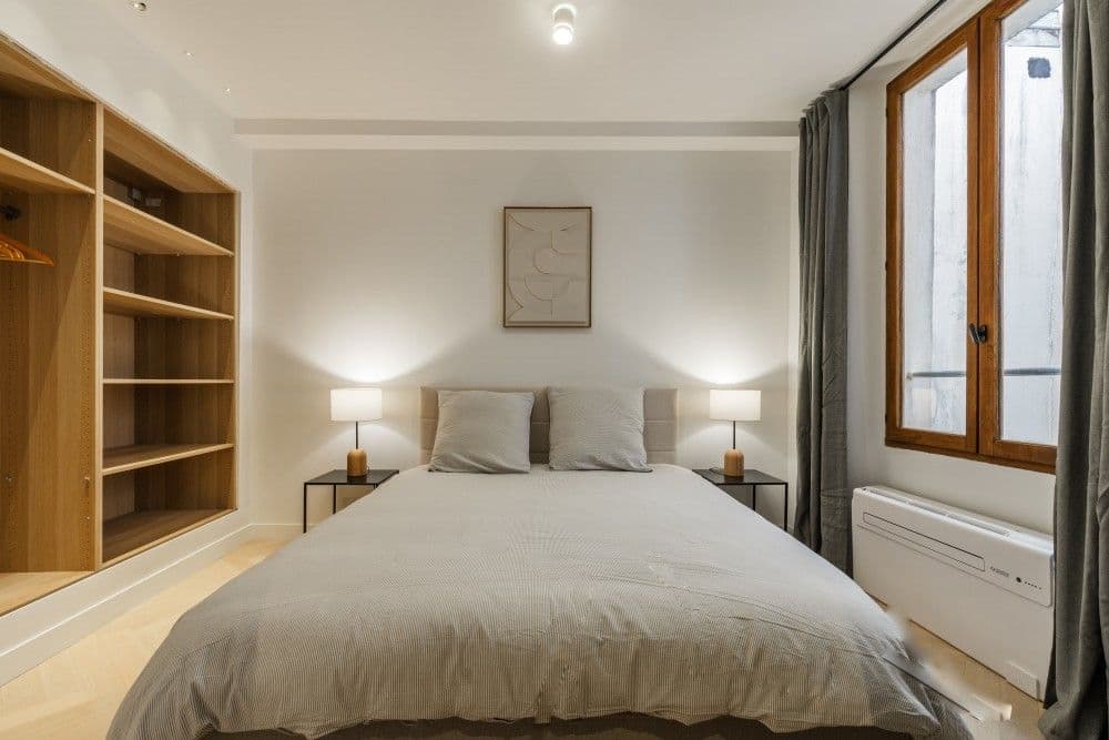 Bedroom with open wooden shelving and window, 2-bedroom apartment in the Old Town, Nice