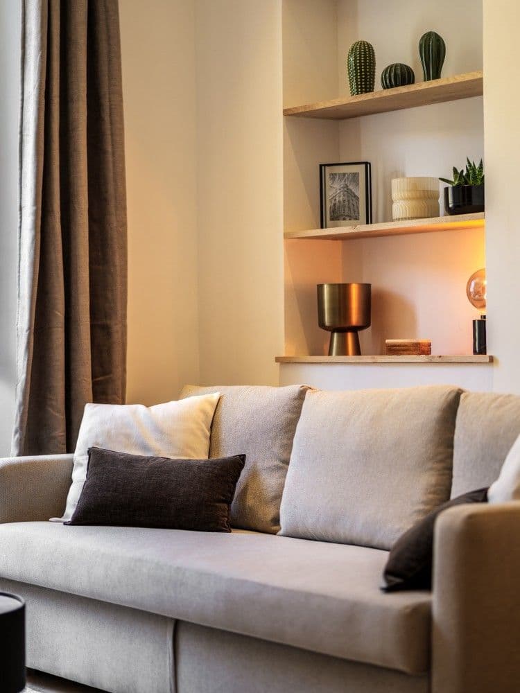 Sofa beneath a shelved alcove, 2-bedroom apartment in the Old Town, Nice