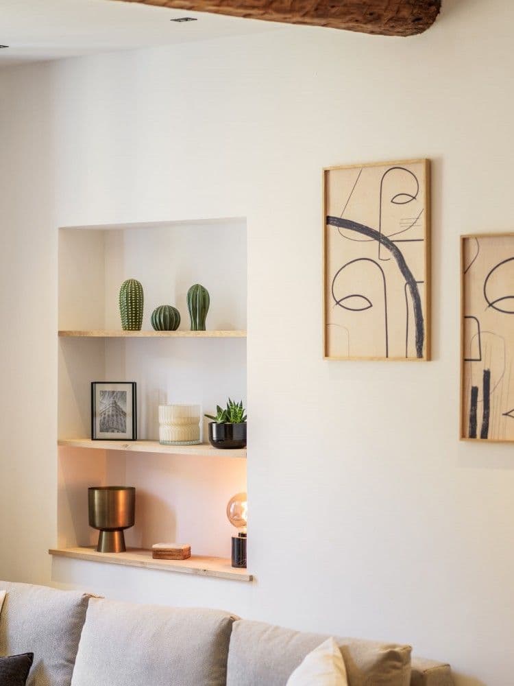 Living room wall with niche shelving and artwork, 2-bedroom apartment in the Old Town, Nice