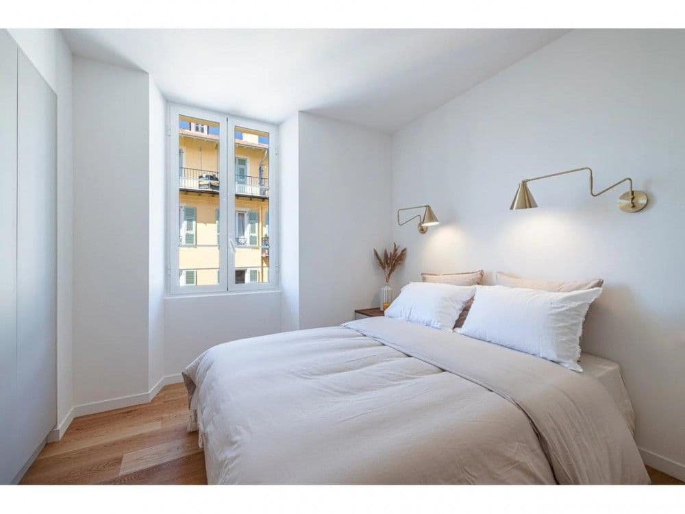 Bedroom with brass wall lights and oak floor, 2-bedroom apartment in the Port, Nice