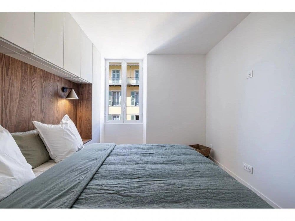Bedroom with walnut headboard wall and fitted storage, 2-bedroom apartment in the Port, Nice