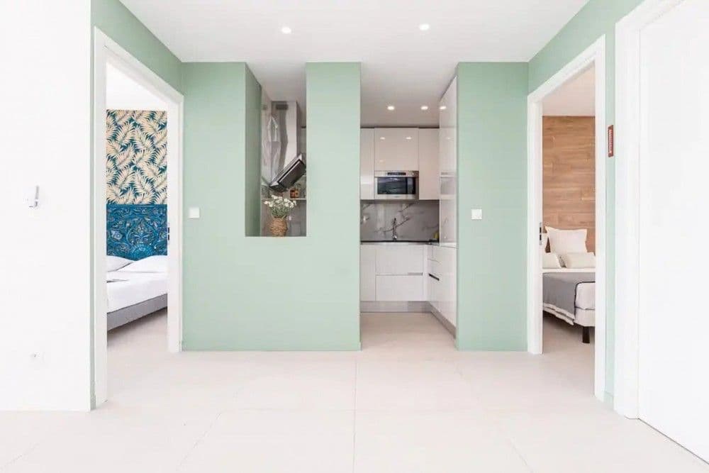 Hallway with mint walls and kitchen beyond, 2-bedroom apartment in the Promenade des Anglais, Nice