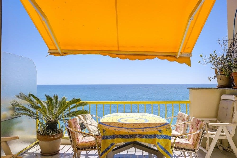 Balcony with awning, dining table and sea view, 2-bedroom apartment in the Promenade des Anglais, Nice
