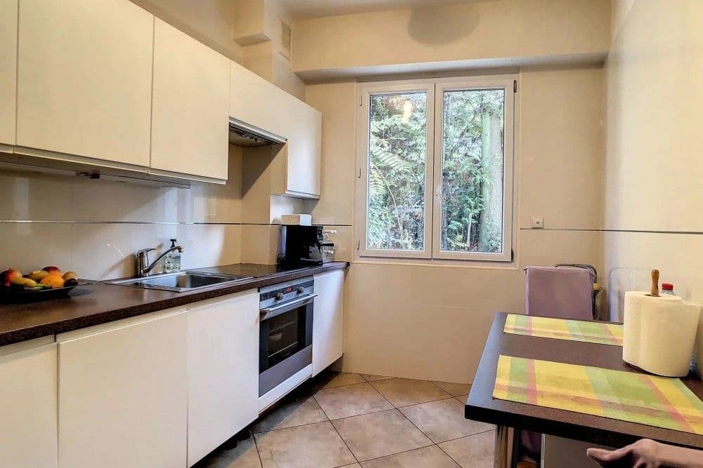 Kitchen with white units and small dining table, 1-bedroom apartment in Mont Boron, Nice