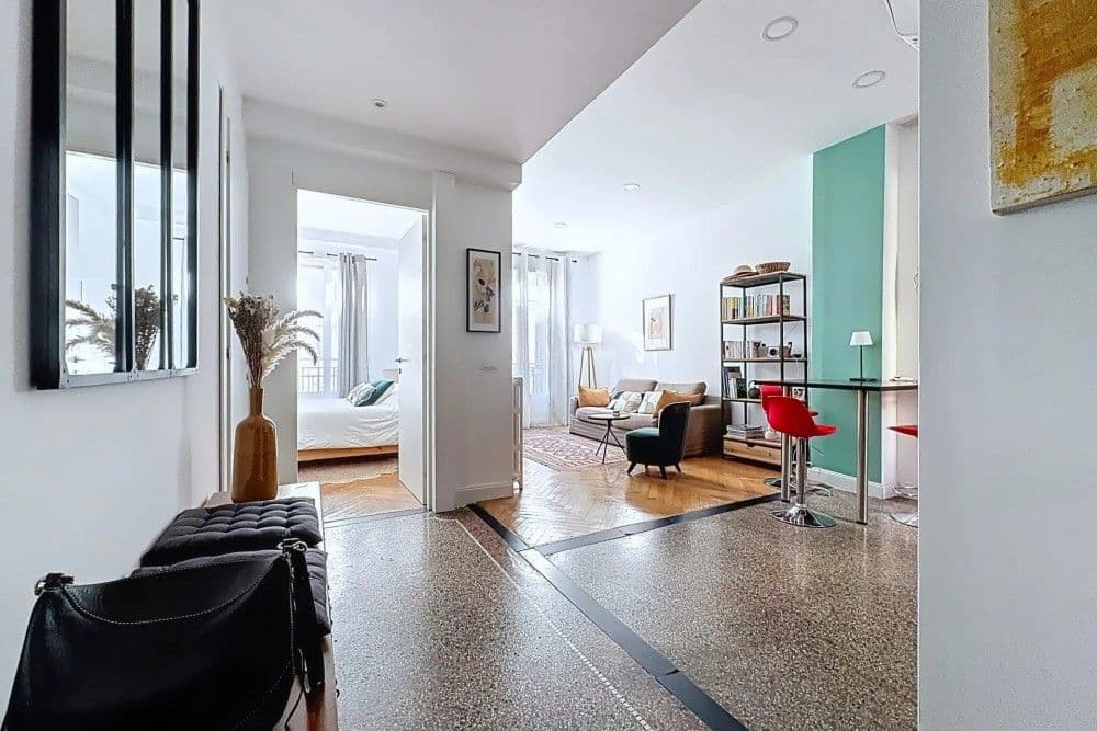 Entrance hall with terrazzo floor and the living room beyond, 1-bedroom apartment in the Port, Nice