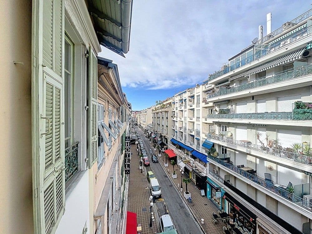 View down a busy street of Belle Époque buildings, 1-bedroom apartment in the Carré d’Or, Nice