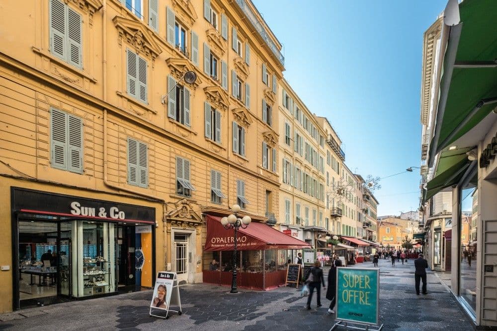 Pedestrian street lined with ochre buildings and cafés, 1-bedroom apartment in the Carré d’Or, Nice
