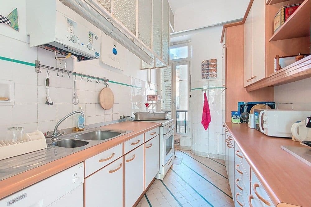 Galley kitchen with window and wooden worktops, 3-bedroom apartment in central Nice