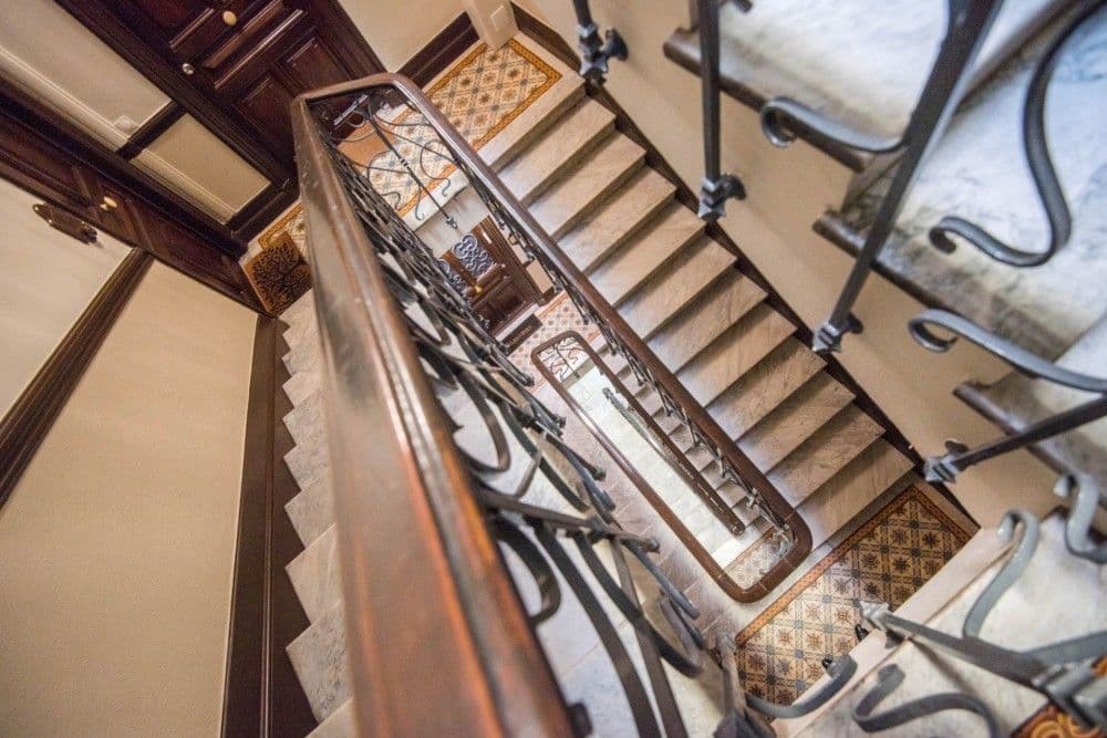 Stairwell with wooden handrail seen from above, 4-bedroom apartment in central Nice