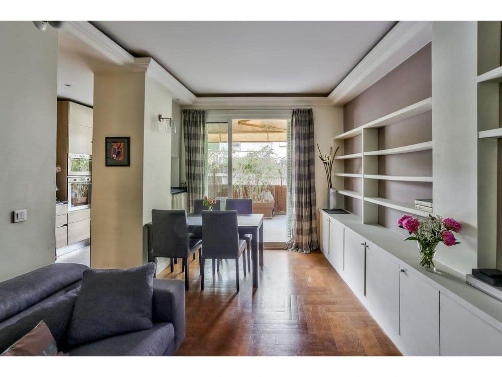 Living and dining room with parquet floor, built-in shelving and doors to the terrace, 2-bedroom apartment in the Port, Nice