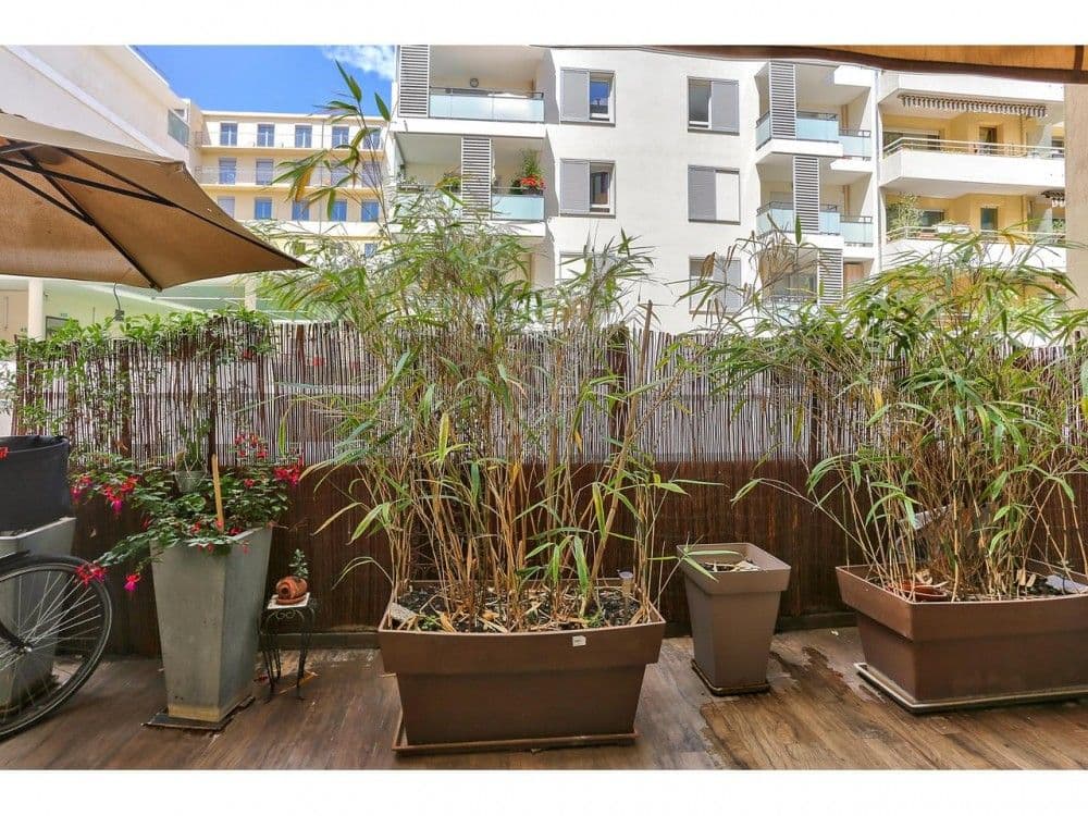 Terrace with bamboo planters and a view of the surrounding buildings, 2-bedroom apartment in the Port, Nice