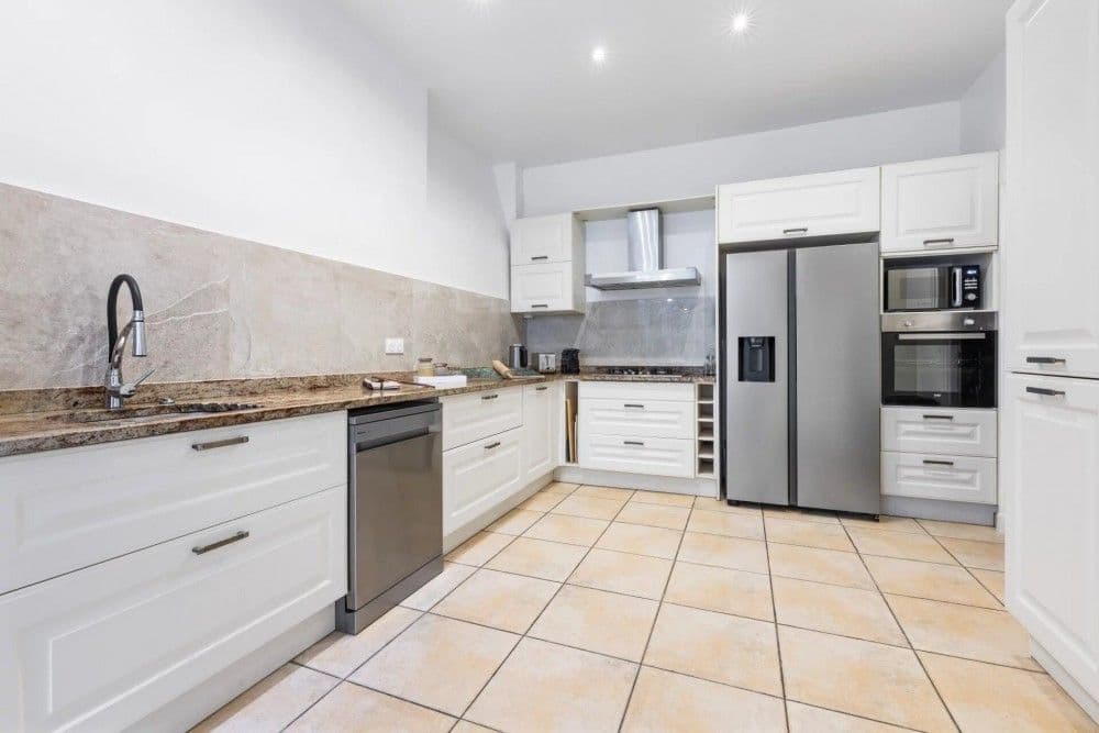 Fitted kitchen with white units and American fridge, 4-bedroom villa in Mont Boron, Nice