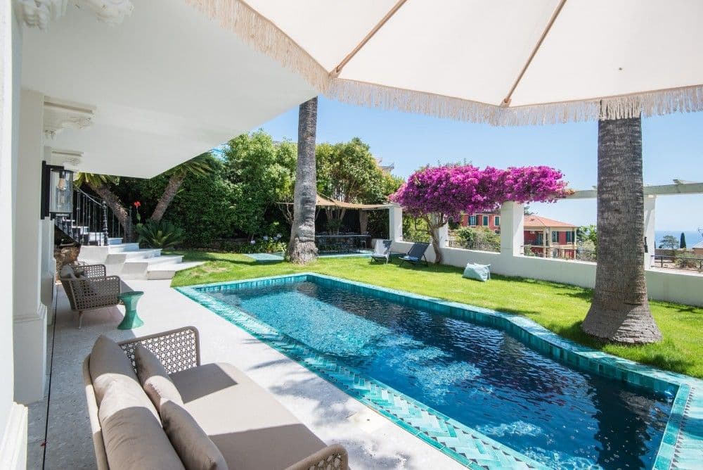 Pool terrace with outdoor sofas under a parasol, 4-bedroom villa in Mont Boron, Nice