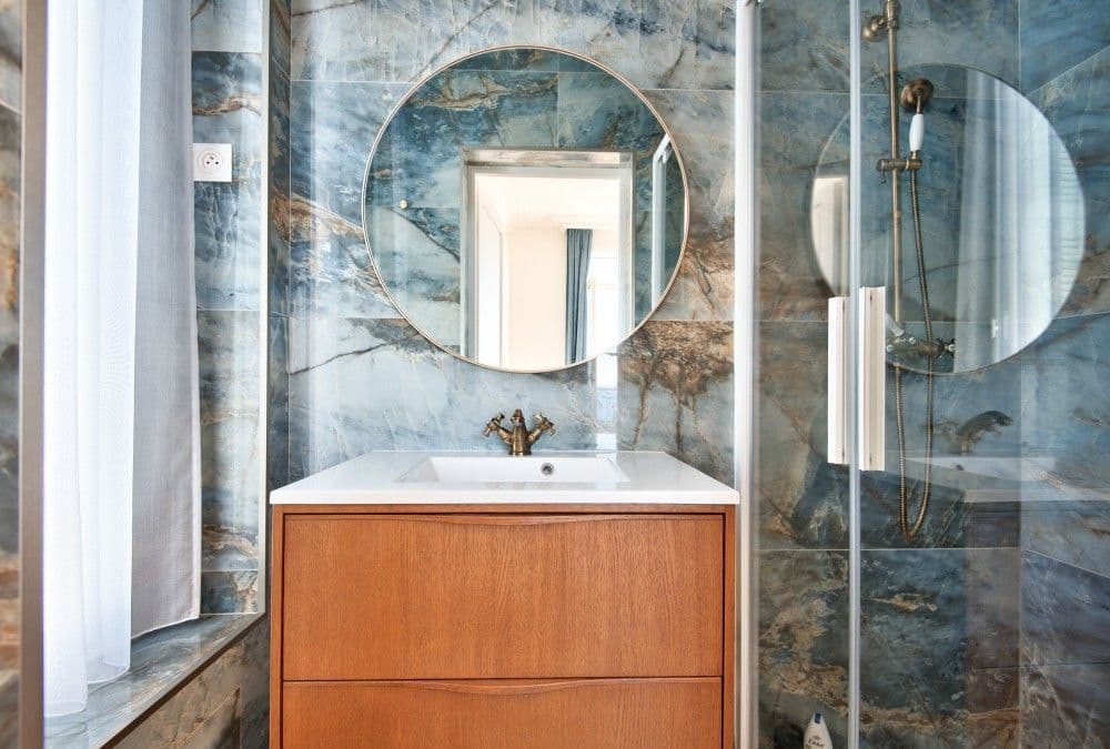 Shower room with blue stone tiles and round mirror, 4-bedroom villa in Mont Boron, Nice