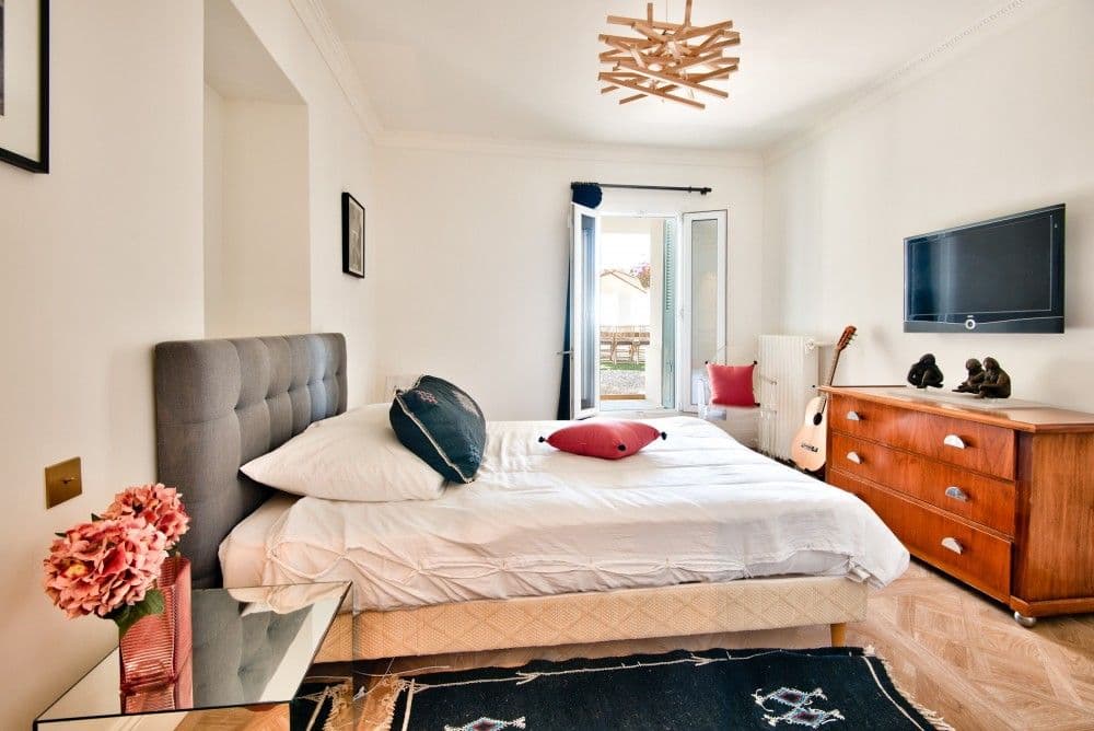 Bedroom with upholstered headboard and window, 4-bedroom villa in Mont Boron, Nice