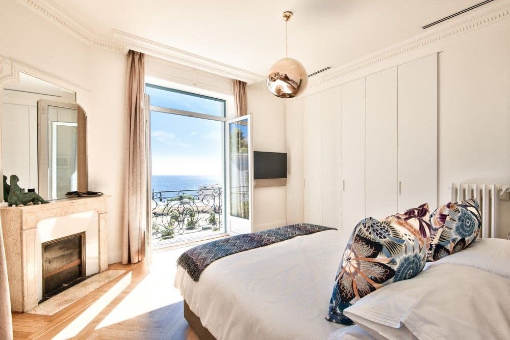 Bedroom with marble fireplace and French window to a sea-view balcony, 4-bedroom villa in Mont Boron, Nice