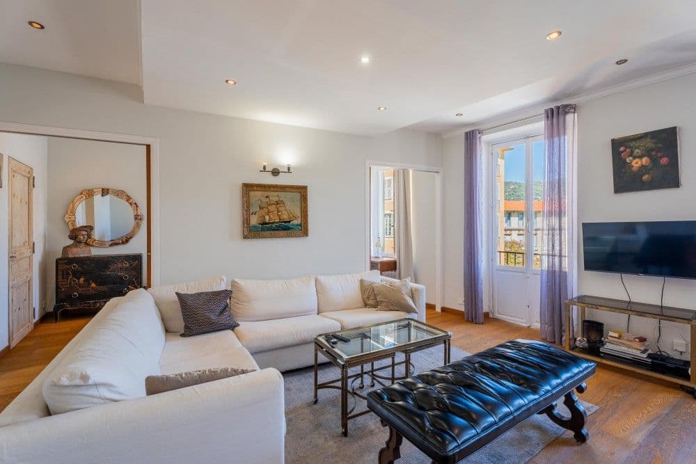 Living room with white sofas and French window, 2-bedroom apartment in the Port, Nice
