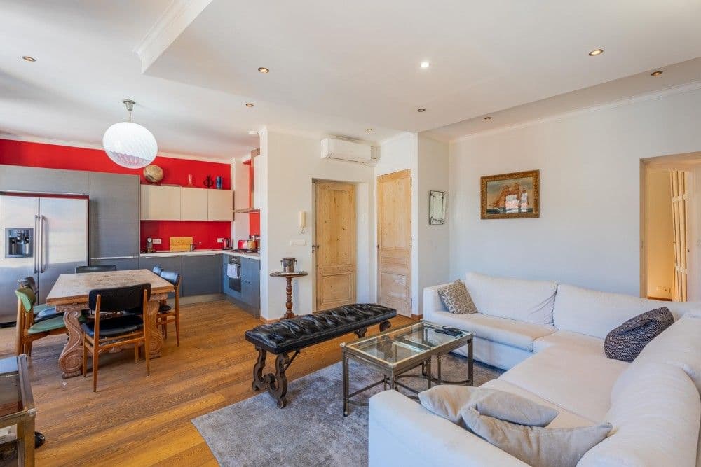 Living room with corner sofa and open kitchen, 2-bedroom apartment in the Port, Nice
