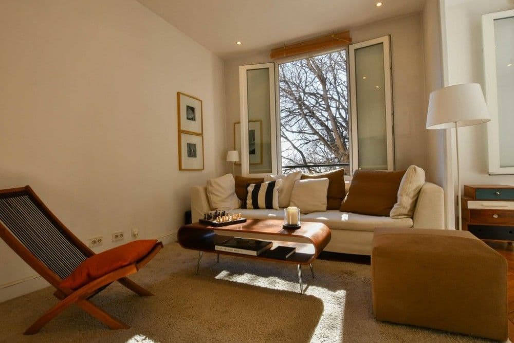 Sitting area with sofa, sling chair and herringbone parquet, 1-bedroom apartment in the Port, Nice