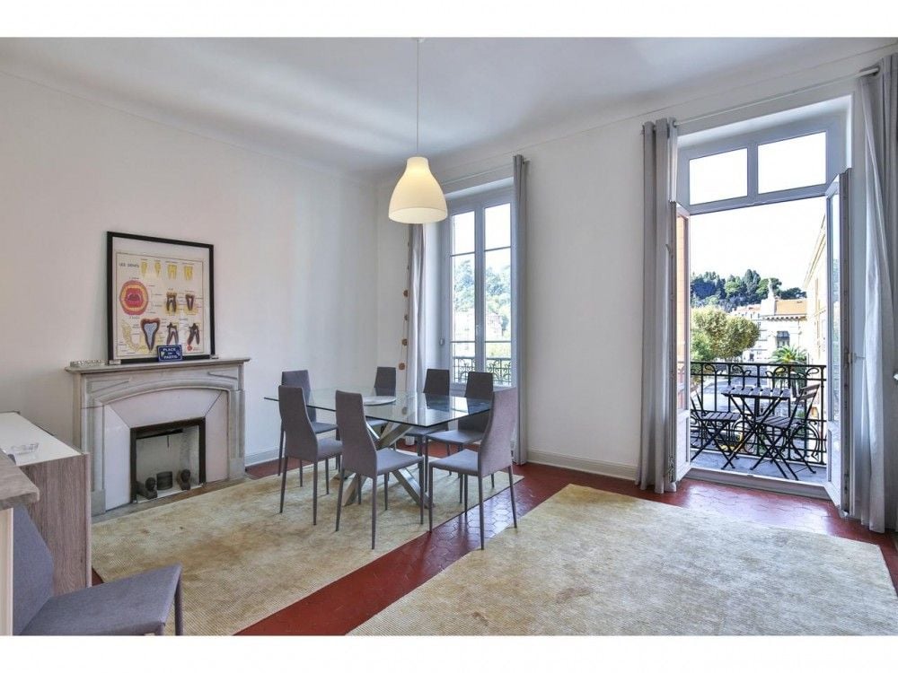 Dining room with marble fireplace and French window to the balcony, 2-bedroom apartment in the Port, Nice