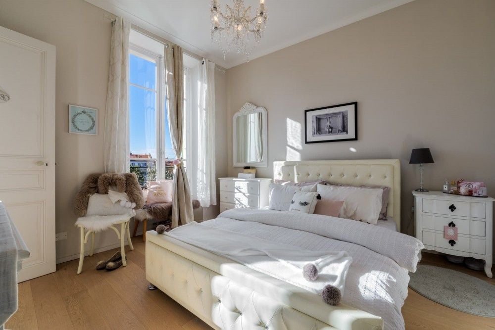 Bedroom with upholstered bed and French windows, 2-bedroom apartment in central Nice