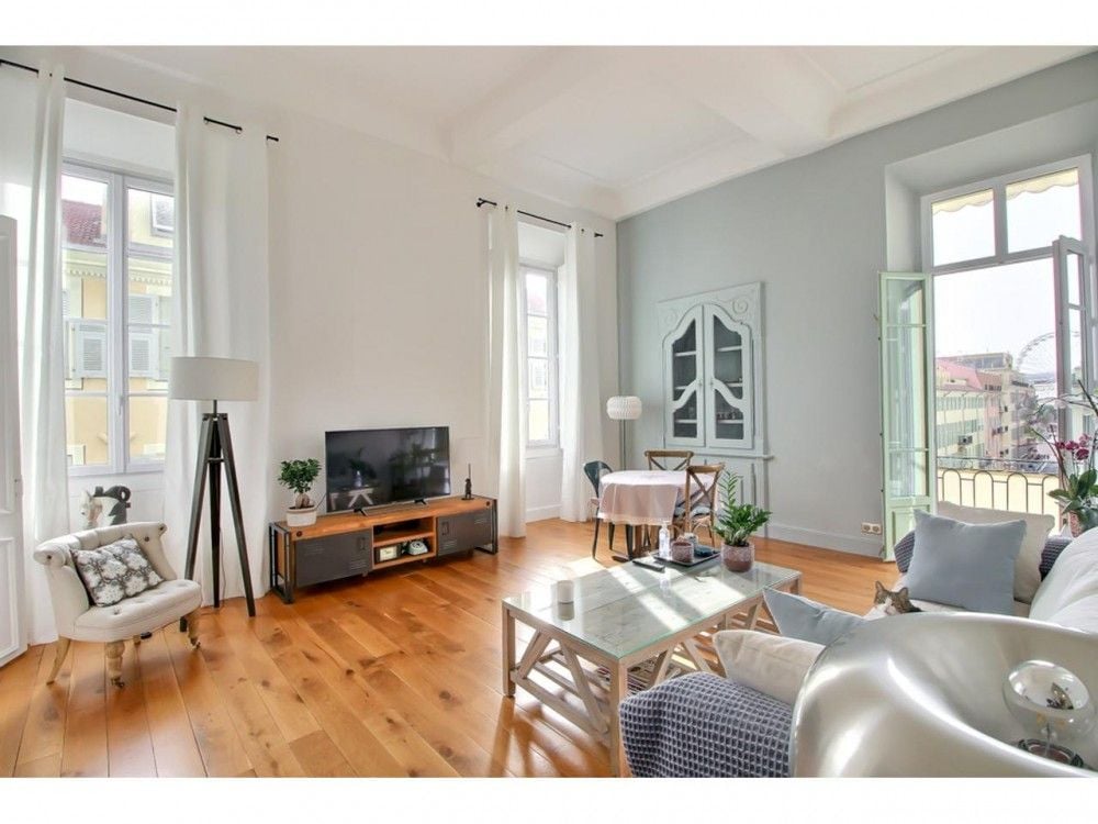 Living room with pale blue walls and French windows to a balcony, 2-bedroom apartment in the Old Town, Nice