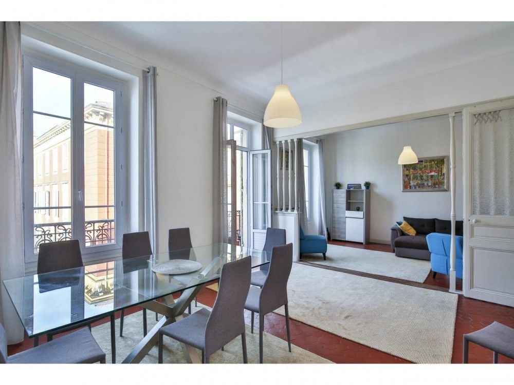 Dining room with glass table and the living room beyond, 2-bedroom apartment in the Port, Nice