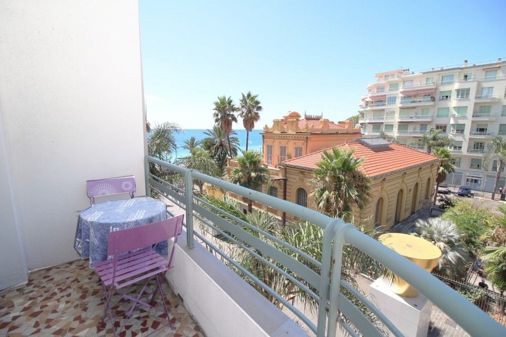 Balcony with bistro set overlooking palms and the sea, 2-bedroom apartment in the Promenade des Anglais, Nice