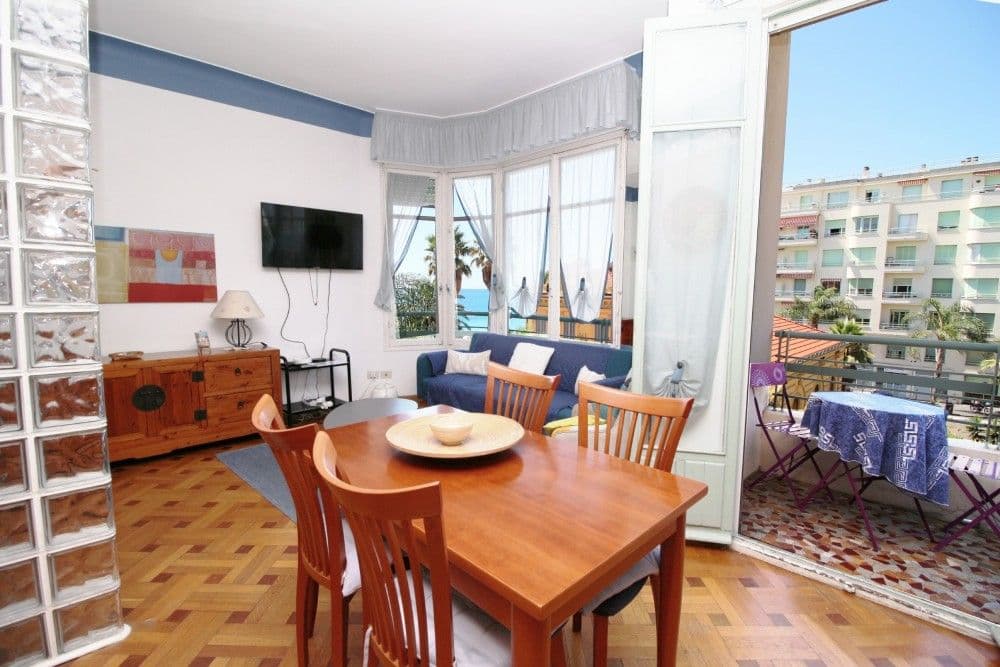 Dining area with doors to the sea-view balcony, 2-bedroom apartment in the Promenade des Anglais, Nice