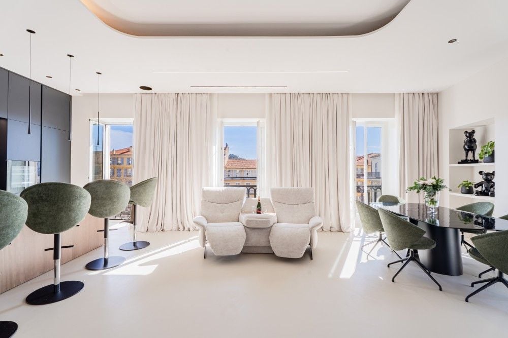 Renovated living room with green velvet chairs and tall windows, 3-bedroom apartment in Wilson, Nice