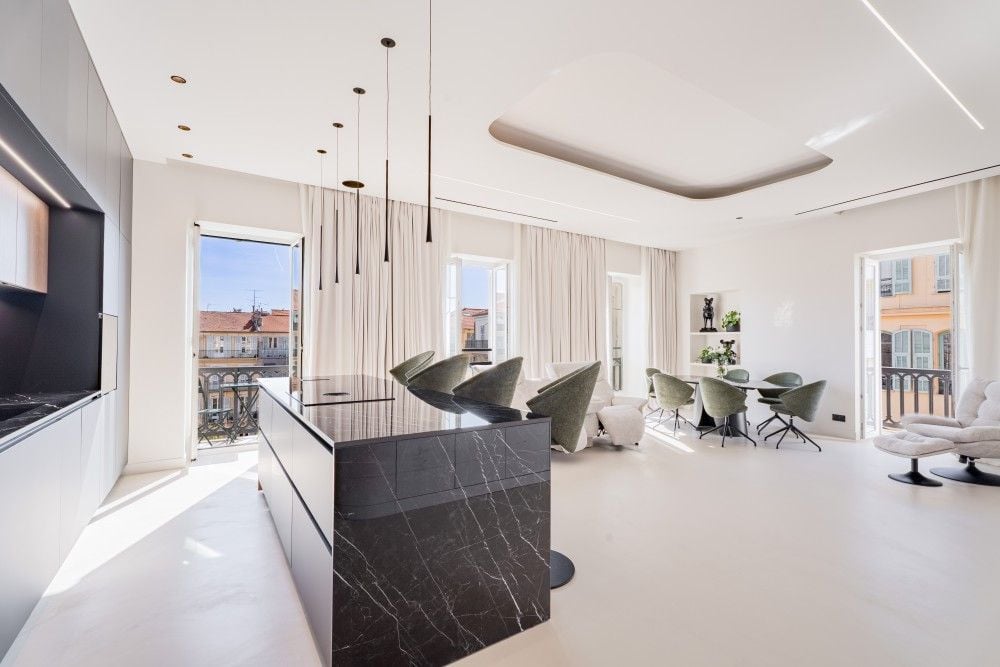 Kitchen with black marble island and living area, 3-bedroom apartment in Wilson, Nice
