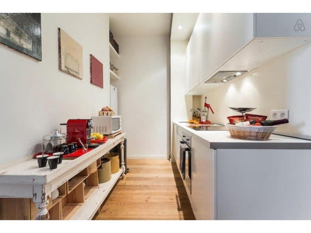 Galley kitchen with white units and open shelving, 2-bedroom apartment in central Nice
