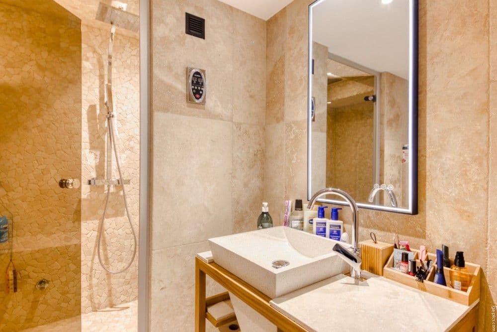 Shower room with travertine walls, vessel basin and walk-in shower, 2-bedroom apartment in the Port, Nice