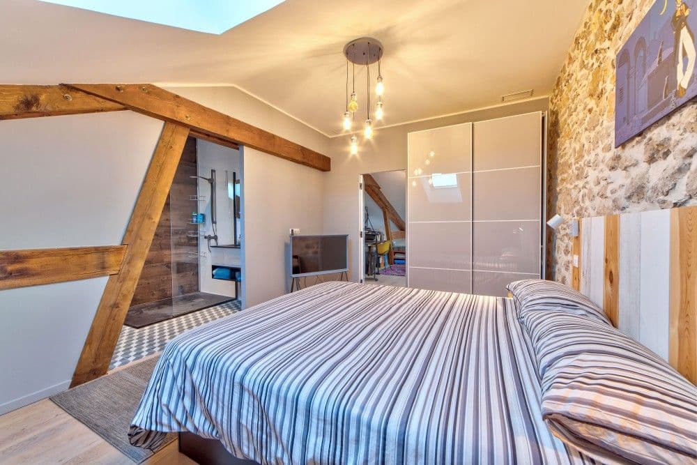 Attic bedroom with exposed beams, stone wall and wardrobe, 2-bedroom apartment in the Port, Nice