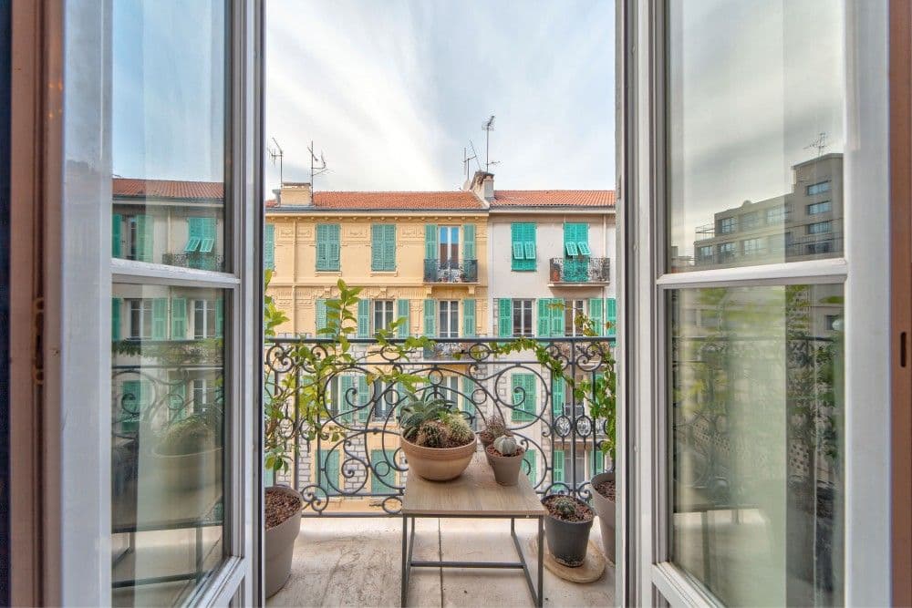 French window to a balcony with a view of pastel façades, 2-bedroom apartment in the Port, Nice