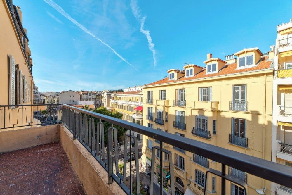 Balcony overlooking ochre Belle Époque façades, 2-bedroom apartment in the Carré d’Or, Nice